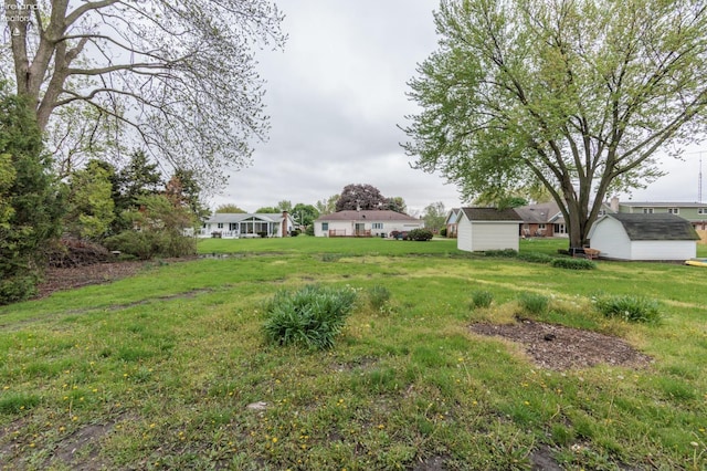 412 E 10th St, Port Clinton, OH 43452 - view of grassy yard featuring a storage unit and an outdoor structure