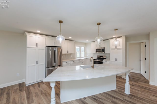 412 E 10th St, Port Clinton, OH 43452 - kitchen featuring appliances with stainless steel finishes, a sink, white cabinetry, wood finished floors, and recessed lighting