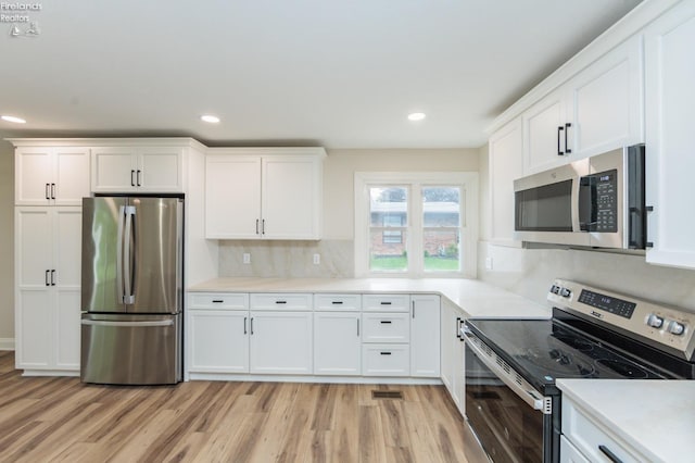 412 E 10th St, Port Clinton, OH 43452 - kitchen with stainless steel appliances, light wood-style flooring, white cabinets, and recessed lighting