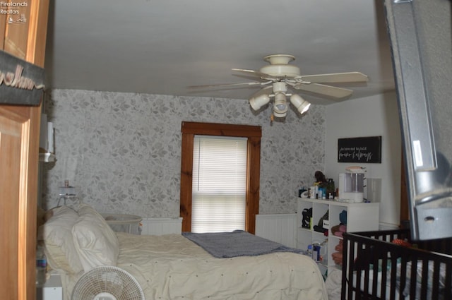 113 W Tiffin St, Attica, OH 44807 - bedroom featuring a wainscoted wall, wallpapered walls, and a ceiling fan