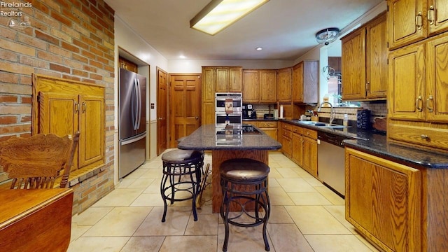 66 Hillcrest Dr, Willard, OH 44890 - kitchen featuring a sink, stainless steel appliances, brown cabinets, tasteful backsplash, and recessed lighting