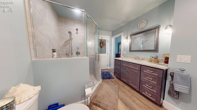 66 Hillcrest Dr, Willard, OH 44890 - full bathroom with a stall shower, toilet, wood finished floors, and vanity