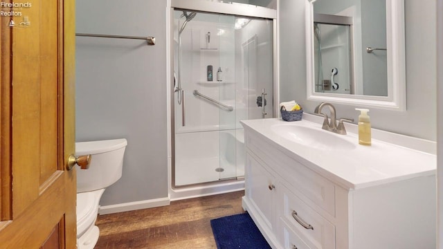 66 Hillcrest Dr, Willard, OH 44890 - bathroom featuring a stall shower, wood finished floors, toilet, vanity, and baseboards