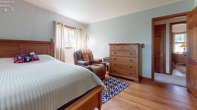66 Hillcrest Dr, Willard, OH 44890 - bedroom featuring crown molding, light wood-type flooring, and baseboards