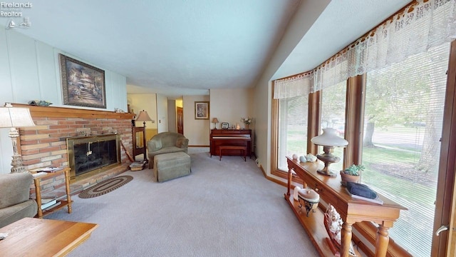66 Hillcrest Dr, Willard, OH 44890 - living room with a fireplace, carpet floors, and vaulted ceiling