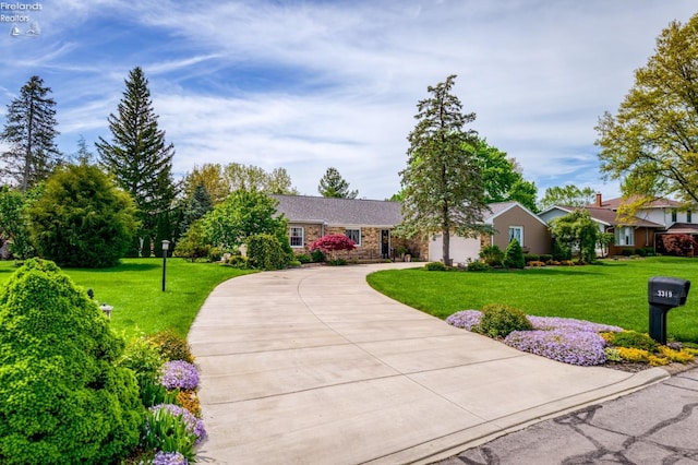 3319 Stonyridge, Sandusky, OH 44870 - ranch-style house featuring curved driveway, a front yard, and a garage