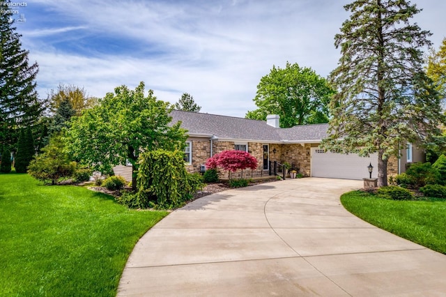 3319 Stonyridge, Sandusky, OH 44870 - view of front of house with stone siding, concrete driveway, a front yard, a chimney, and a garage