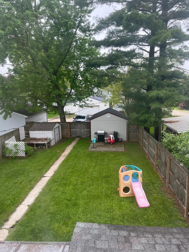 81 Melissa St, Tiffin, OH 44883 - view of yard with a storage unit, an outdoor structure, and a playground