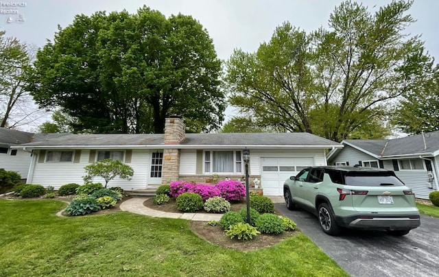 5 Old State Rd, Norwalk, OH 44857 - ranch-style house featuring an attached garage, asphalt driveway, stone siding, a front lawn, and a chimney