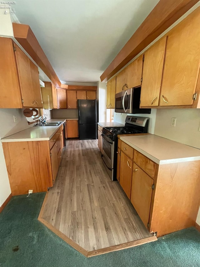 5 Old State Rd, Norwalk, OH 44857 - kitchen featuring stainless steel appliances, a sink, light countertops, and brown cabinetry