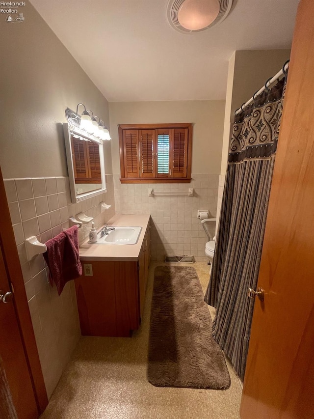 5 Old State Rd, Norwalk, OH 44857 - full bathroom with tile walls, toilet, vanity, and wainscoting