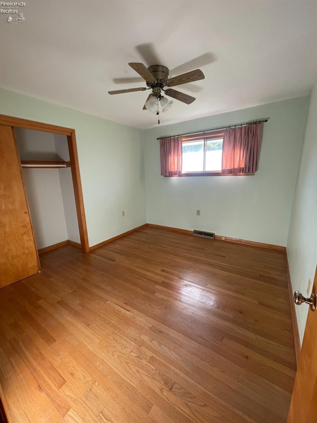 5 Old State Rd, Norwalk, OH 44857 - unfurnished bedroom featuring light wood-style flooring, a closet, ceiling fan, and baseboards