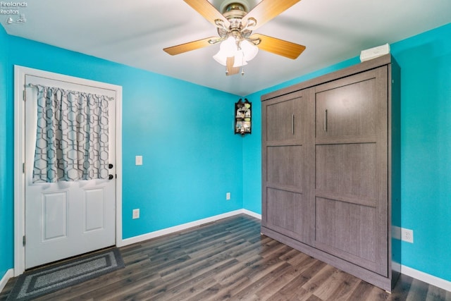 515 Berlin Rd, Huron, OH 44839 - unfurnished bedroom with dark wood-style floors, baseboards, ceiling fan, and a closet