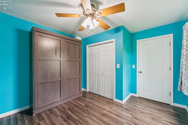 515 Berlin Rd, Huron, OH 44839 - unfurnished bedroom with baseboards, wood finished floors, a closet, and a ceiling fan