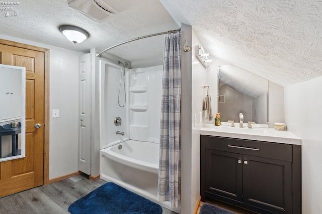 515 Berlin Rd, Huron, OH 44839 - bathroom with a textured ceiling, wood finished floors, shower / tub combo with curtain, baseboards, and vanity
