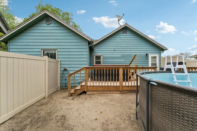 515 Berlin Rd, Huron, OH 44839 - rear view of house with a deck, fence, and an outdoor pool