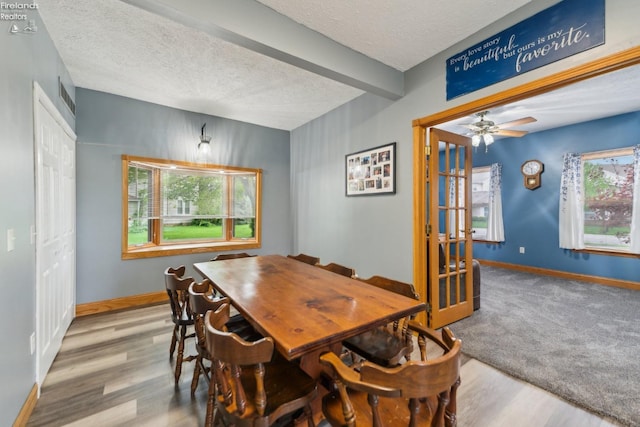 515 Berlin Rd, Huron, OH 44839 - dining space featuring healthy amount of natural light, a textured ceiling, baseboards, wood finished floors, and beam ceiling