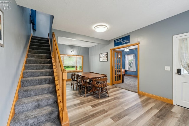515 Berlin Rd, Huron, OH 44839 - dining space with light wood-style flooring, stairway, french doors, and baseboards