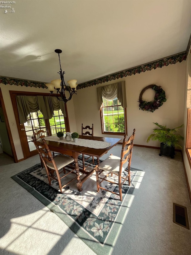 378 Lelar St, Tiffin, OH 44883 - dining area with a chandelier, carpet flooring, and baseboards