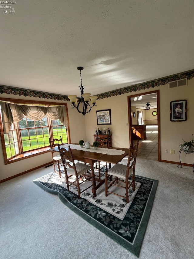 378 Lelar St, Tiffin, OH 44883 - carpeted dining area featuring a chandelier, baseboards, and a textured ceiling