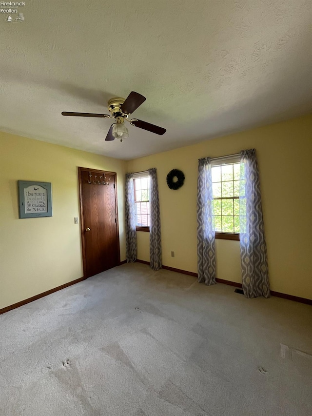 378 Lelar St, Tiffin, OH 44883 - spare room featuring a ceiling fan, carpet, baseboards, and a textured ceiling