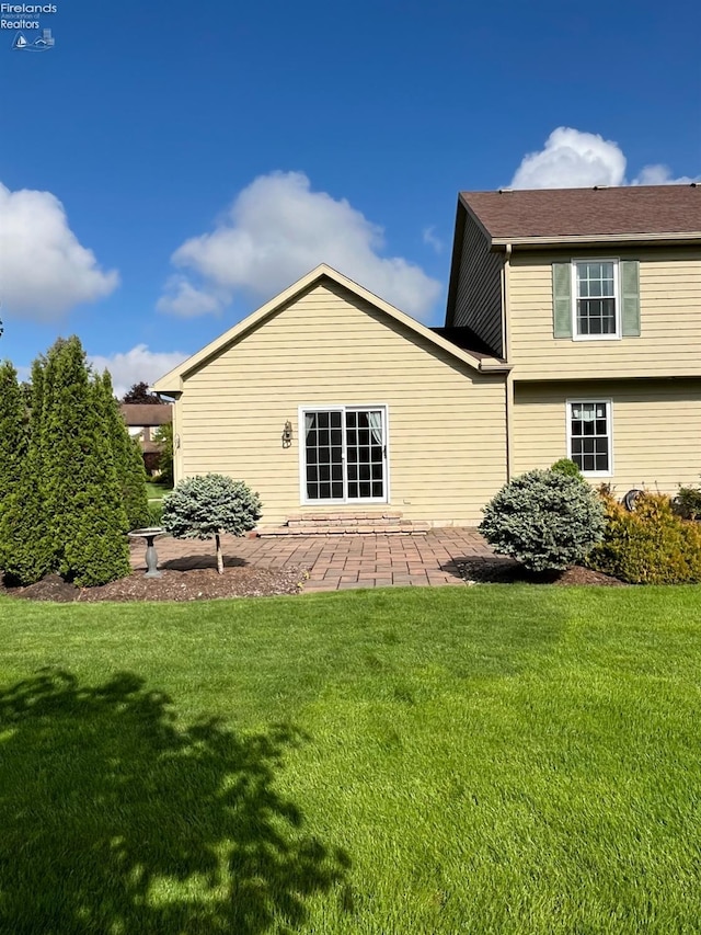 378 Lelar St, Tiffin, OH 44883 - back of property with a lawn and a patio