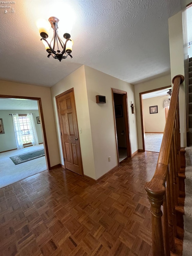 378 Lelar St, Tiffin, OH 44883 - spare room with baseboards, stairway, a chandelier, and a textured ceiling