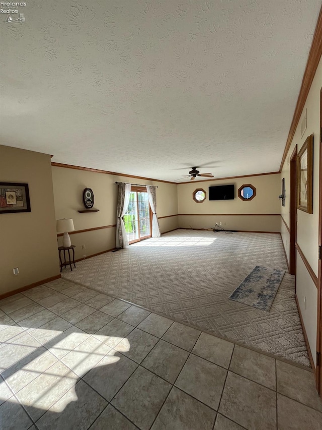 378 Lelar St, Tiffin, OH 44883 - unfurnished living room featuring carpet, a textured ceiling, ceiling fan, tile patterned flooring, and crown molding