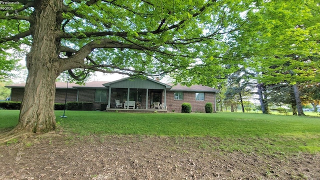 903 N Warpole, Upper Sandusky, OH 43351 - rear view of house featuring brick siding and a yard