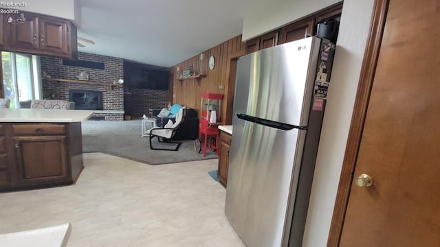 903 N Warpole, Upper Sandusky, OH 43351 - kitchen featuring freestanding refrigerator, light floors, a brick fireplace, light countertops, and open floor plan
