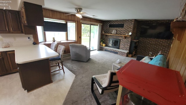 903 N Warpole, Upper Sandusky, OH 43351 - living area with ceiling fan, a brick fireplace, light carpet, and brick wall