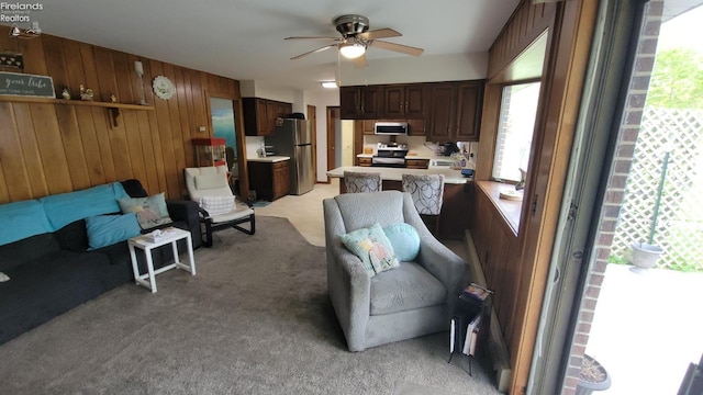 903 N Warpole, Upper Sandusky, OH 43351 - living area featuring healthy amount of natural light, light carpet, wood walls, and ceiling fan