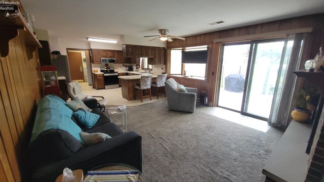 903 N Warpole, Upper Sandusky, OH 43351 - living area with ceiling fan, light colored carpet, and wooden walls