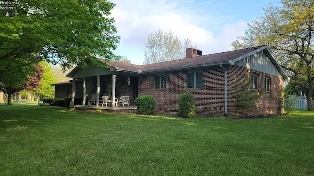 903 N Warpole, Upper Sandusky, OH 43351 - rear view of property featuring a chimney, a lawn, and brick siding