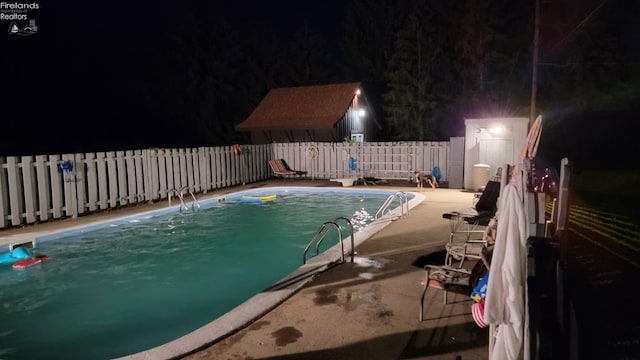 903 N Warpole, Upper Sandusky, OH 43351 - pool at night featuring a fenced backyard and a patio area