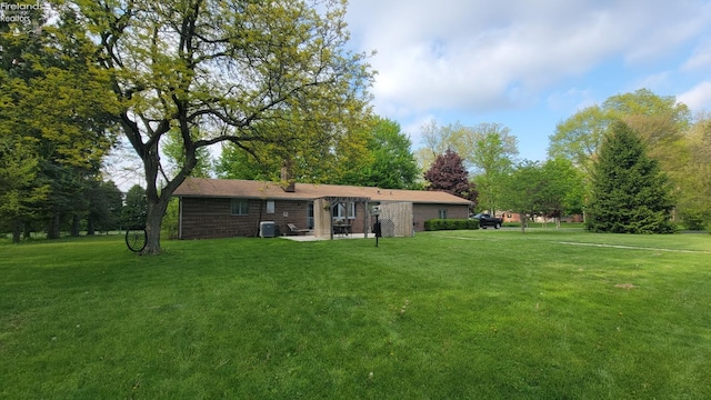 903 N Warpole, Upper Sandusky, OH 43351 - rear view of house with a lawn, cooling unit, a patio, and brick siding