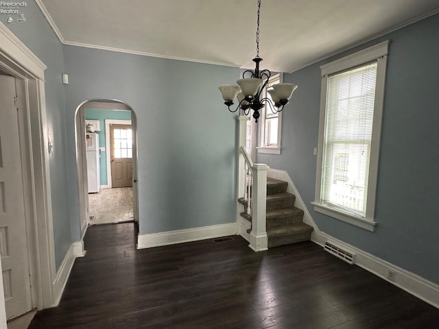 515 W Osborne St, Sandusky, OH 44870 - unfurnished dining area featuring arched walkways, ornamental molding, baseboards, dark wood-style floors, and a chandelier