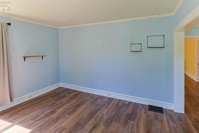 unfurnished room with wood finished floors, crown molding, and baseboards
