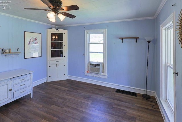 unfurnished dining area with ornamental molding, dark wood-style flooring, a ceiling fan, baseboards, and cooling unit