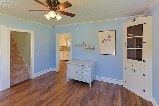 bedroom featuring crown molding, dark wood-type flooring, and baseboards