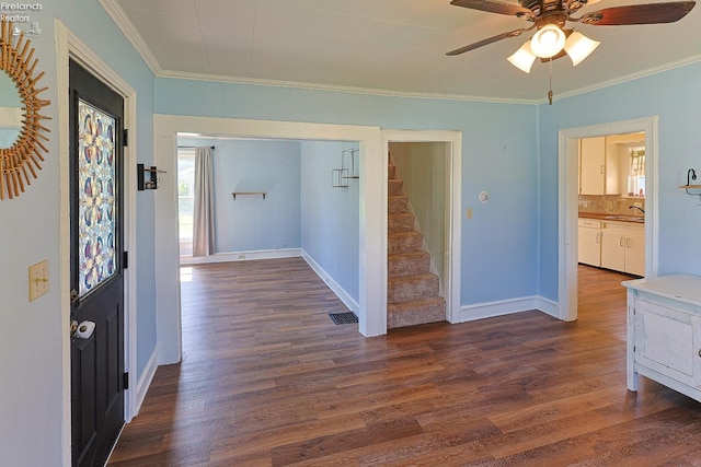 hallway with crown molding, stairway, dark wood finished floors, and a sink