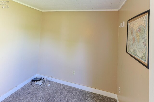 carpeted spare room with baseboards and ornamental molding