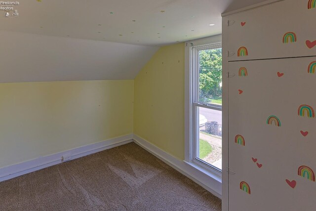 bonus room featuring vaulted ceiling, carpet floors, and baseboards