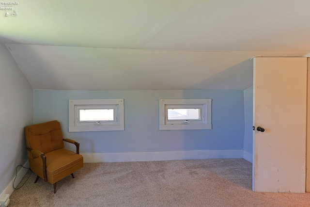 unfurnished room with carpet floors, lofted ceiling, and baseboards