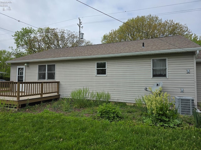 715 Cherry Ave, Lakeside, OH 43440 - rear view of house with central AC unit, a wooden deck, and a lawn