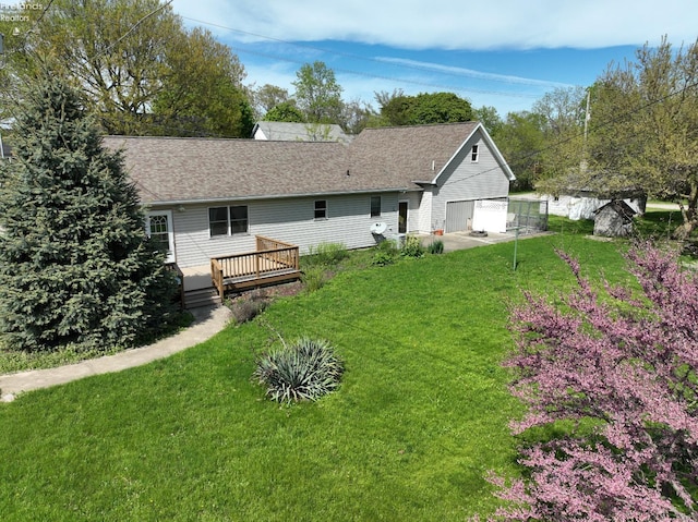 715 Cherry Ave, Lakeside, OH 43440 - rear view of property with a wooden deck, a yard, a shingled roof, and a garage