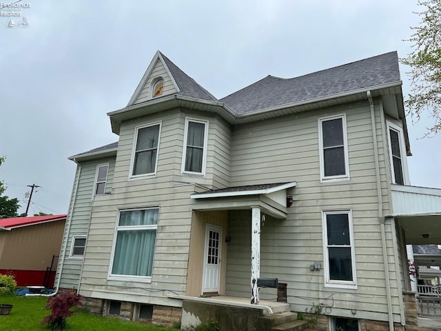 525 N Main St, Fostoria, OH 44830 - rear view of house with a shingled roof