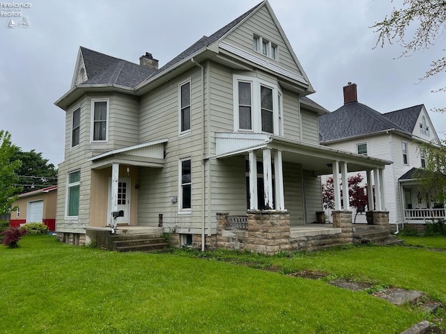 525 N Main St, Fostoria, OH 44830 - back of house featuring a porch, a yard, and a chimney