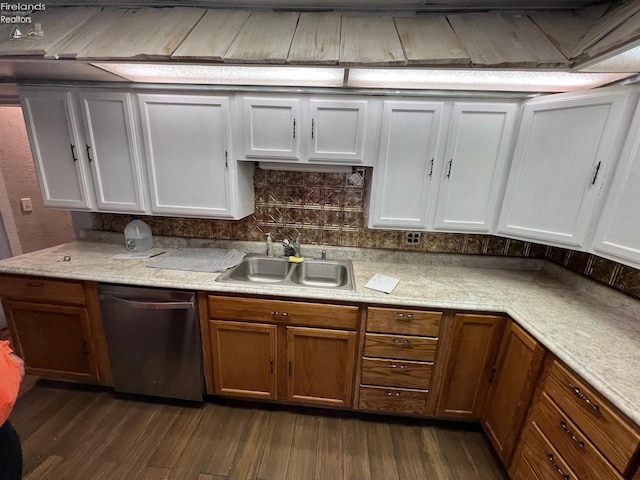 525 N Main St, Fostoria, OH 44830 - kitchen featuring stainless steel dishwasher, a sink, dark wood-style floors, light countertops, and tasteful backsplash