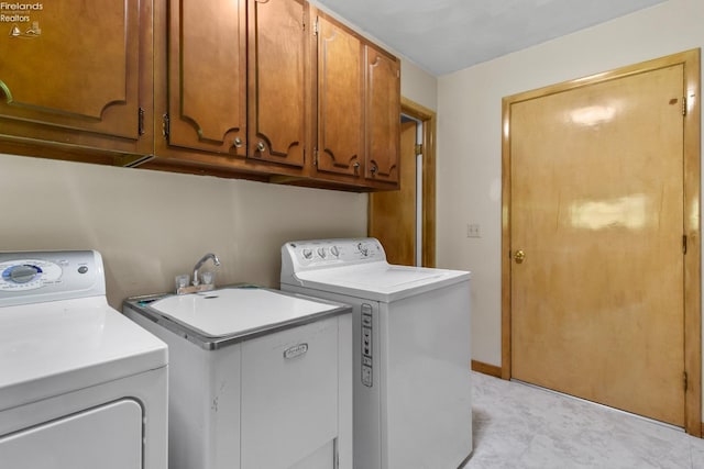 washroom with washing machine and clothes dryer and cabinet space